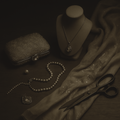 Vintage jewelry and accessories including a necklace, pearls, a clutch, and scissors on a dark surface.